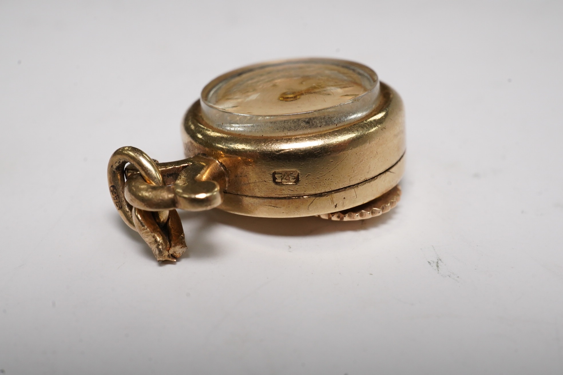 A lady's 9ct Jaeger LeCoultre manual back wind pendant watch, case diameter 15mm, gross weight 7.1 grams. Condition - fair